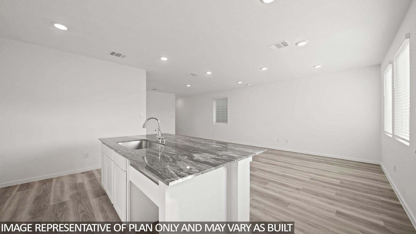 228 Flying Tigers Trail Jarrell, TX 76537 - Photo 4 of 17 Kitchen island featuring a stainless steel sink and a contemporary gooseneck faucet