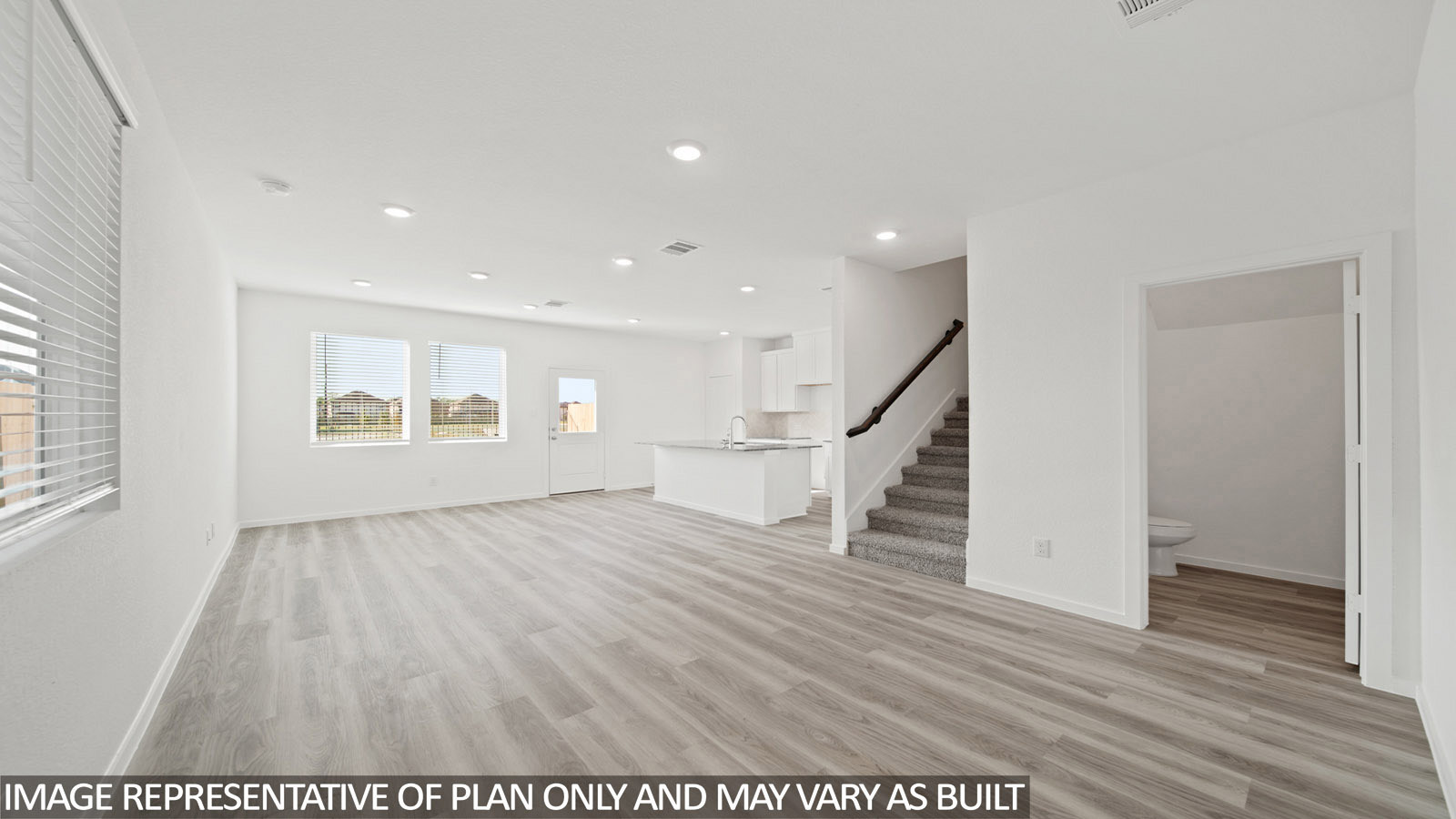 228 Flying Tigers Trail Jarrell, TX 76537 - Photo 6 of 17 Open-concept main living area featuring wide plank wood-finish flooring, recessed lighting, and large windows