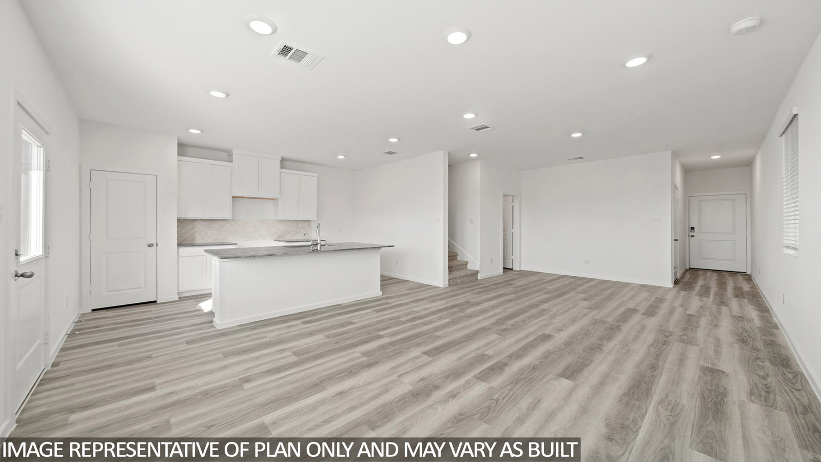 228 Flying Tigers Trail Jarrell, TX 76537 - Photo 8 of 17 Expansive open-concept living area featuring light wood-finish flooring, a contemporary kitchen island with seating, recessed lighting, and white cabinetry