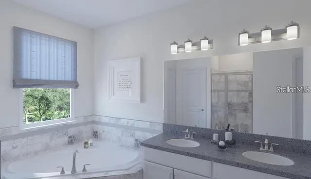 a bathroom with a bathtub a sink and a window