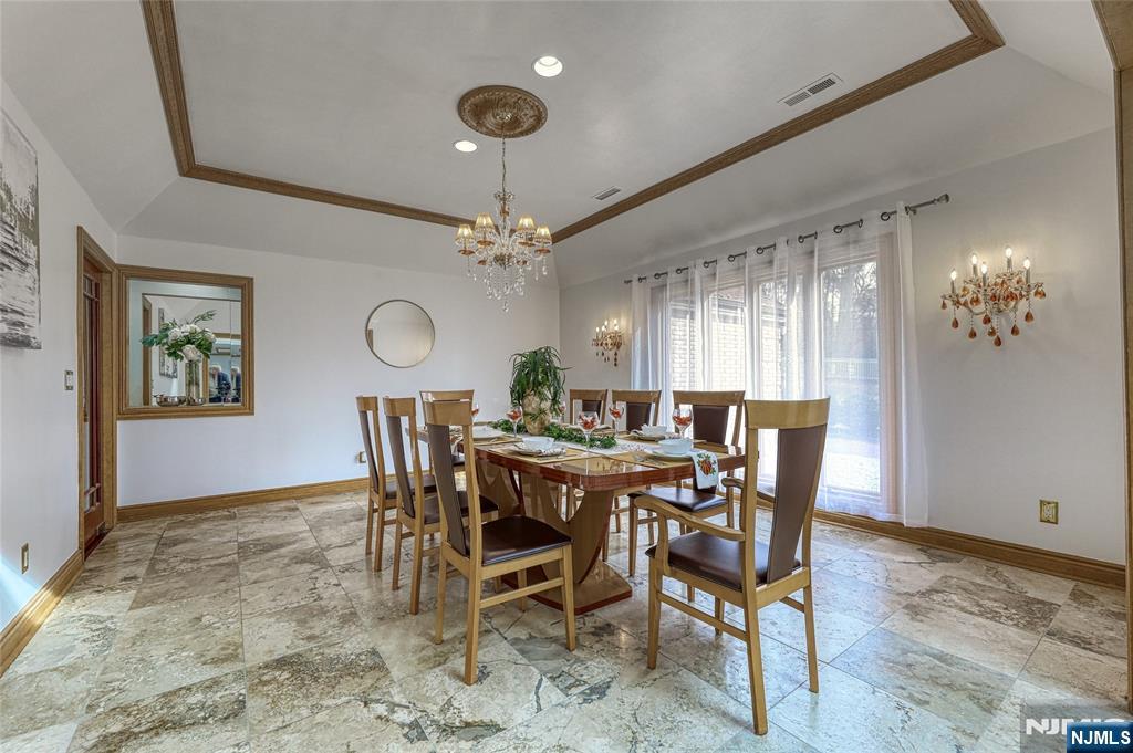 91 Chestnut Ridge Road Saddle River, NJ 07458 - Photo 12 of 41 a view of a dining room with furniture and chandelier