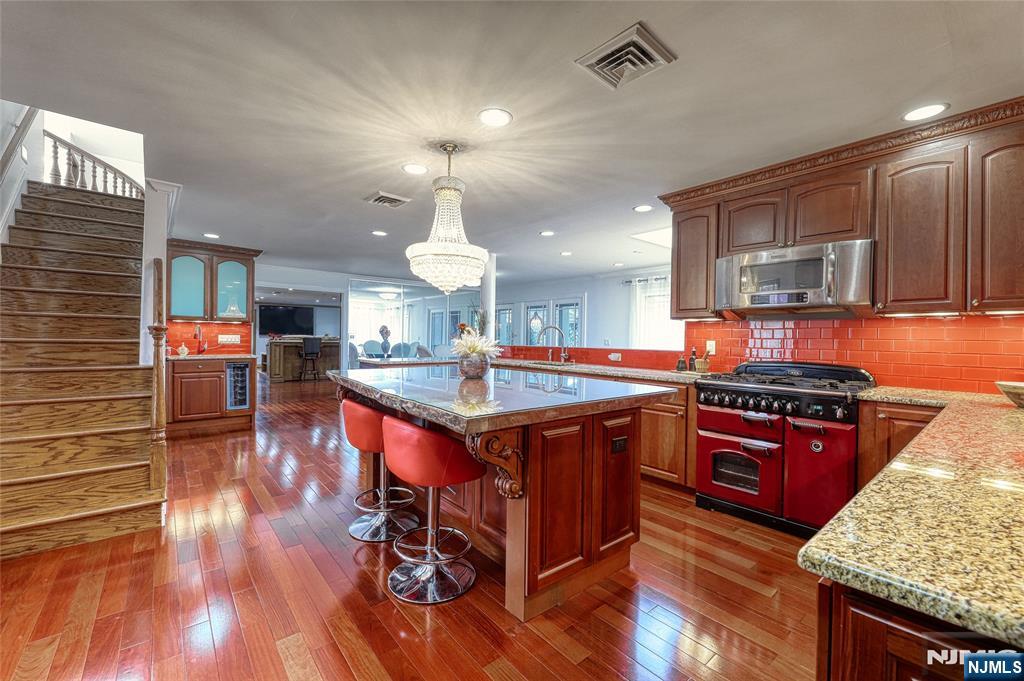91 Chestnut Ridge Road Saddle River, NJ 07458 - Photo 13 of 41 a kitchen with stainless steel appliances granite countertop a stove and a wooden floors