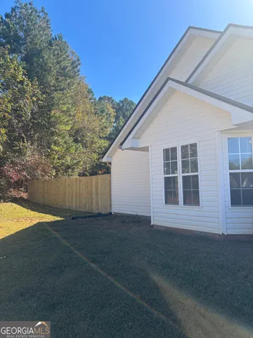 a view of backyard with large tree