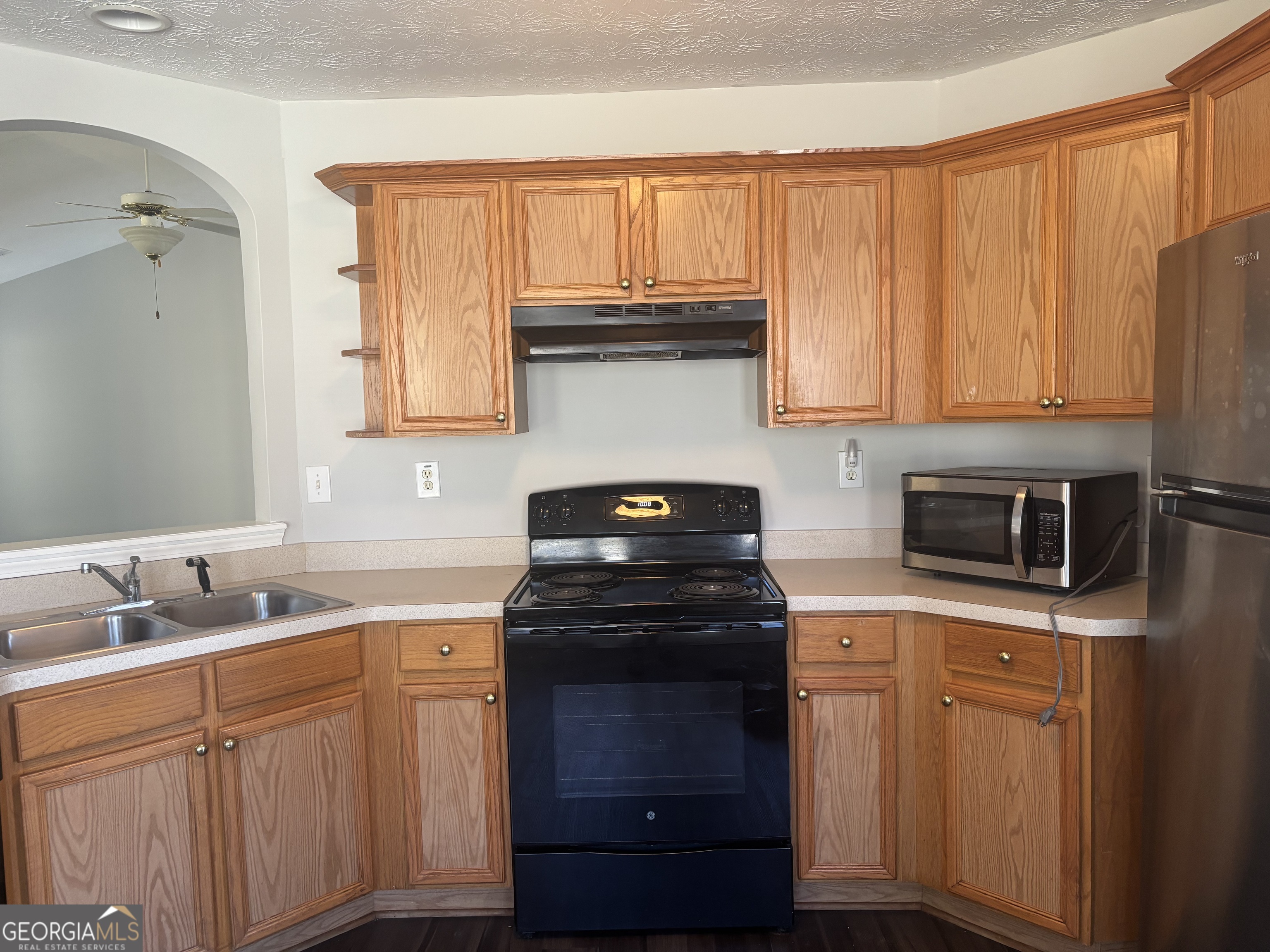 15 Tabitha Court Covington, GA 30016 - Photo 5 of 10 a kitchen with granite countertop a stove sink and cabinets