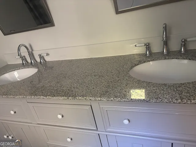 a bathroom with sink and mirror