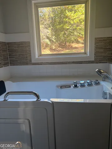 a bathroom with a sink and a window