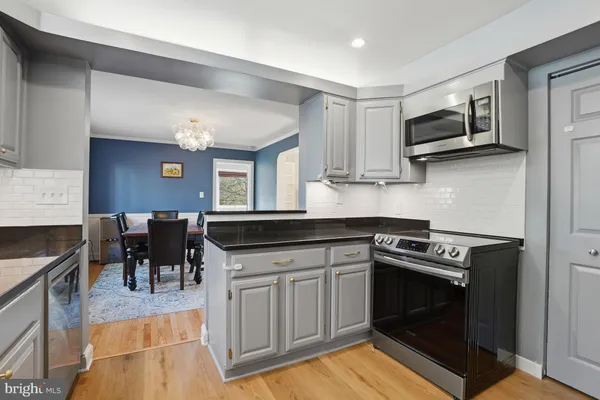 a kitchen with granite countertop a sink and wooden cabinets