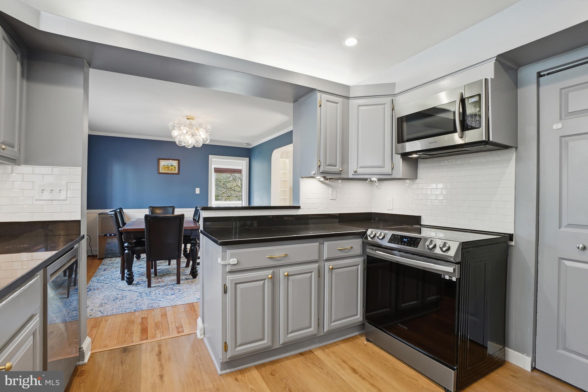 1303 Ballard Street Silver Spring, MD 20910 - Photo 17 of 53 a kitchen with granite countertop a stove and a sink