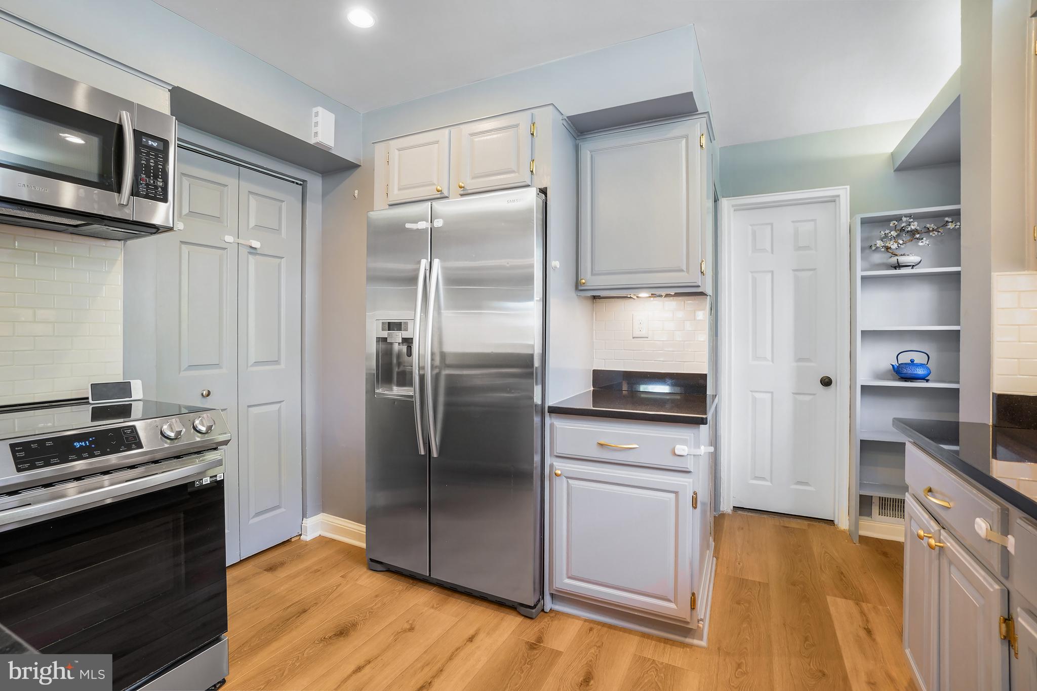 1303 Ballard Street Silver Spring, MD 20910 - Photo 19 of 53 a kitchen with stainless steel appliances and wooden floor