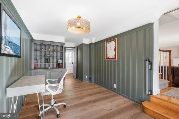 a room with a wooden floor and cabinets