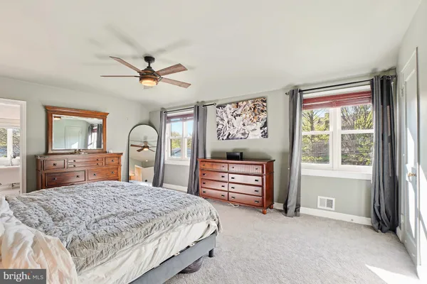 a bedroom with a bed dresser and a window