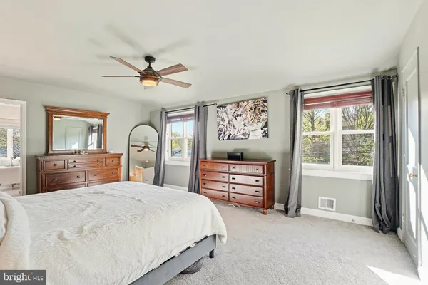 a bedroom with a bed dresser and a window