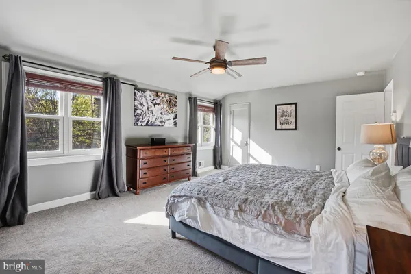 a bathroom with a sink double vanity mirror and a bathtub
