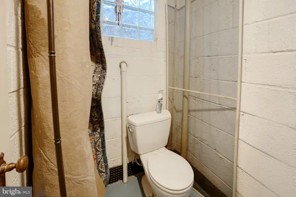 a white toilet sitting next to a bathroom sink