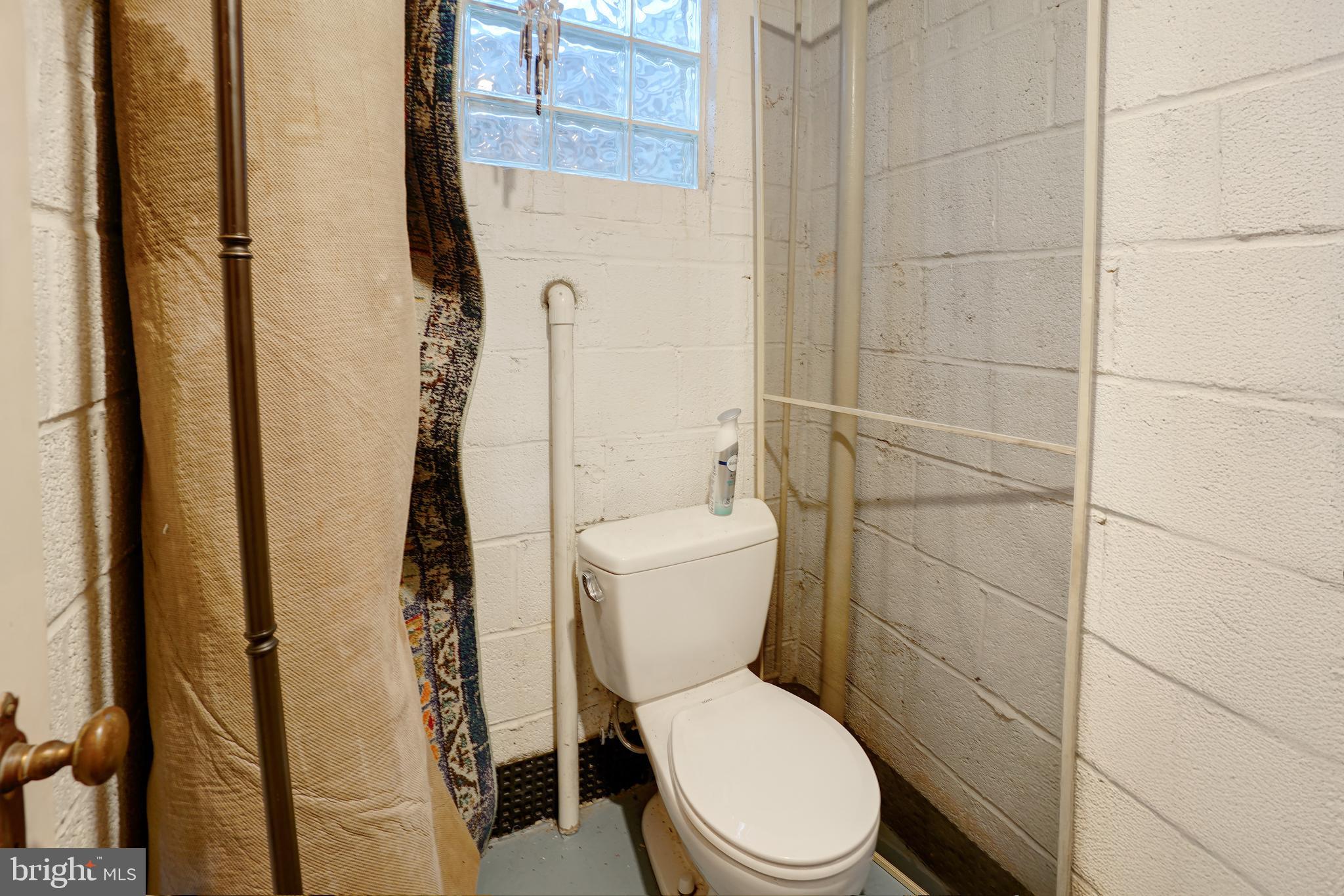 1303 Ballard Street Silver Spring, MD 20910 - Photo 47 of 53 a white toilet sitting next to a shower curtain
