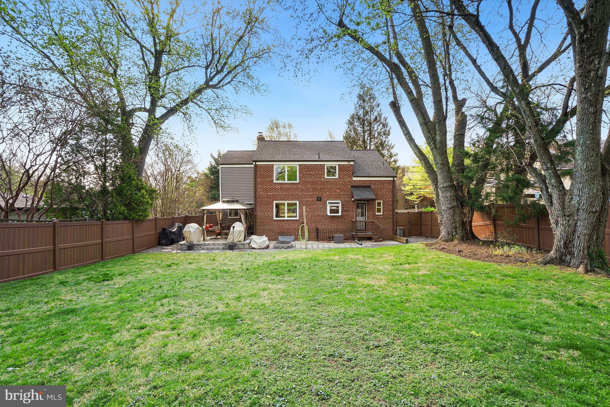 1303 Ballard Street Silver Spring, MD 20910 - Photo 5 of 53 a view of a front of a house with a big yard and large trees