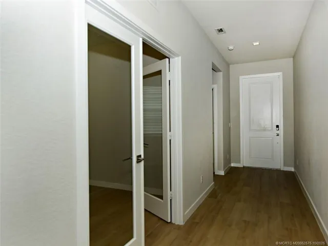 an empty room with a window and a ceiling fan