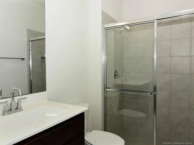 a view of a kitchen with a sink wooden floor and a window
