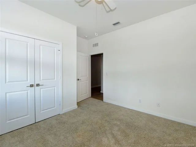 a view of a room with wooden floor and windows