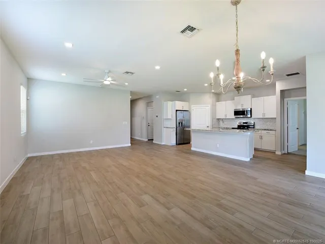 a kitchen with a sink window and refrigerator