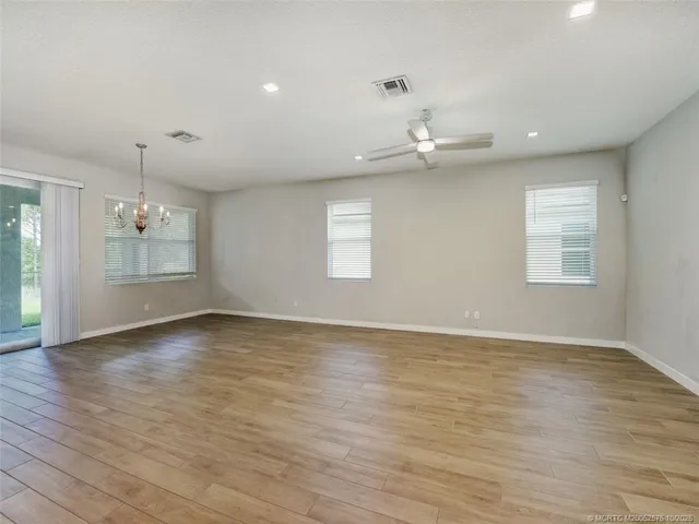 a view of an empty room with a ceiling fan