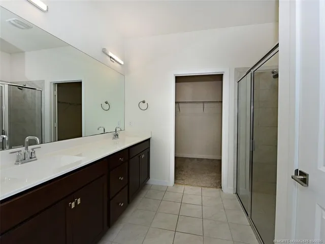 a spacious bathroom with a double vanity sink mirror and double