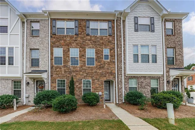 a view of a brick building next to a yard