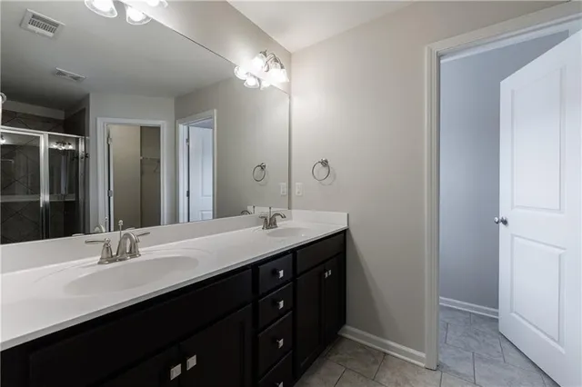 a bathroom with a double vanity sink a and a mirror