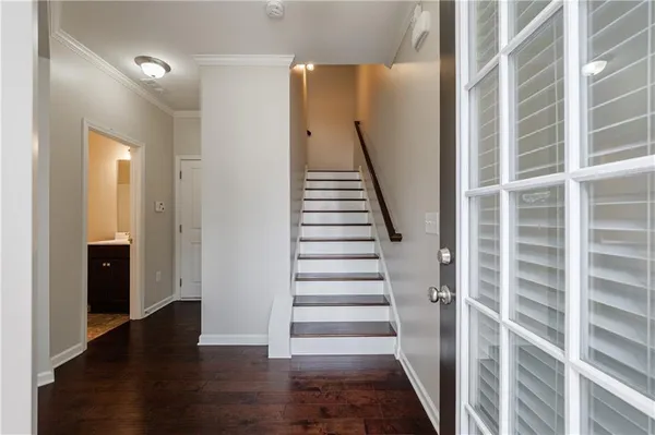 a view of entryway with wooden floor and stairs