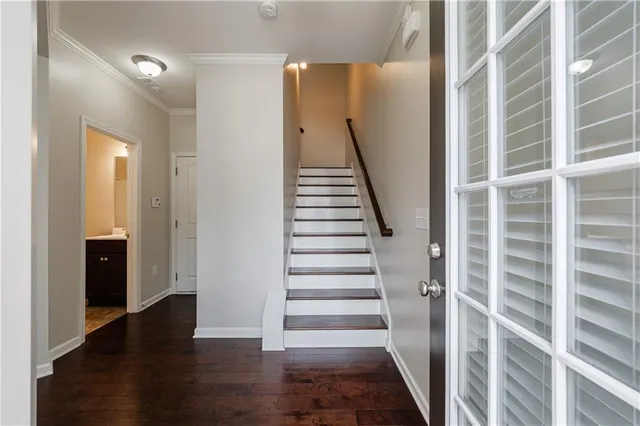 a view of entryway with wooden floor and stairs