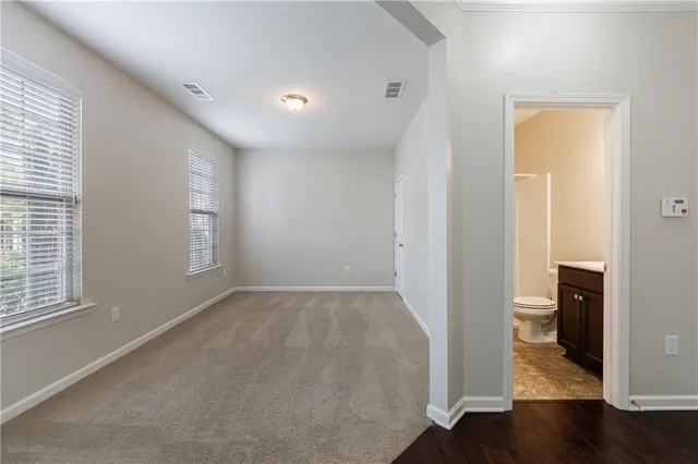an empty room with wooden floor and a window