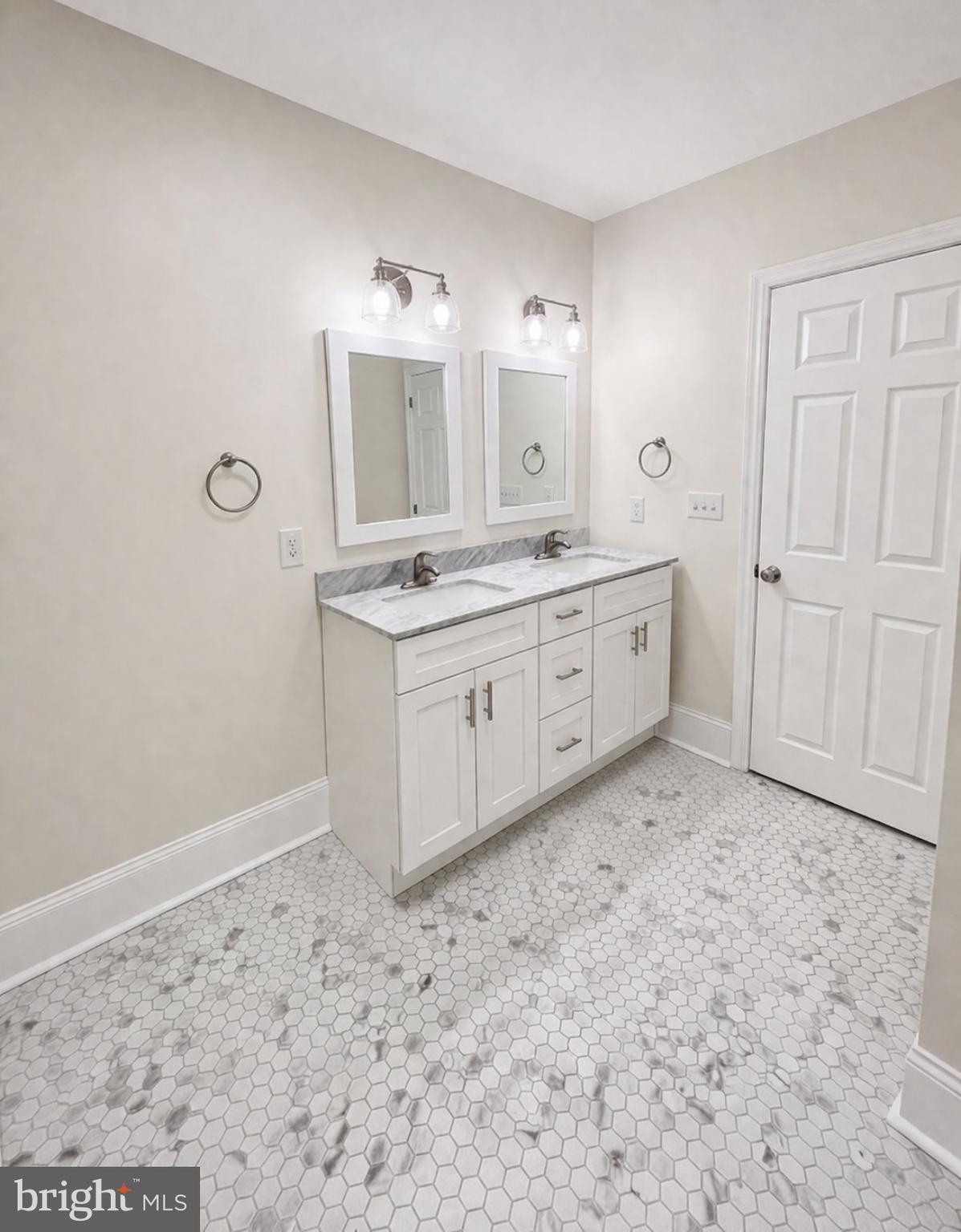 22 Maple Street Conshohocken, PA 19428 - Photo 14 of 22 a spacious bathroom with a granite countertop sink and a mirror