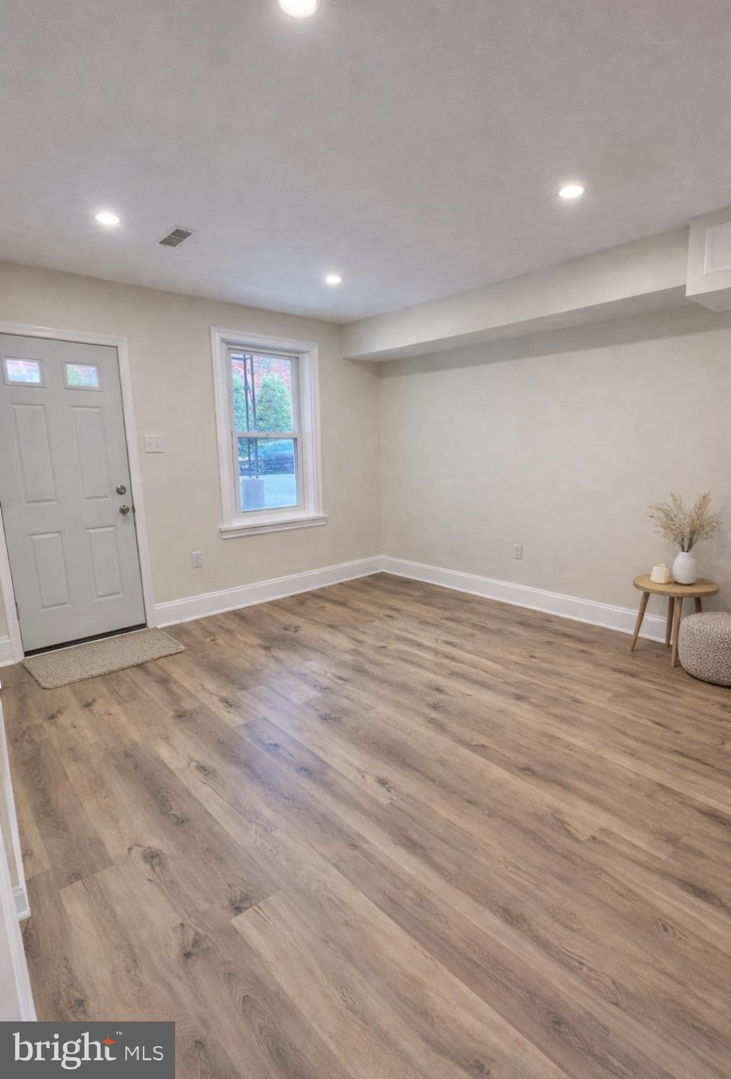 22 Maple Street Conshohocken, PA 19428 - Photo 2 of 22 an empty room with wooden floor and windows