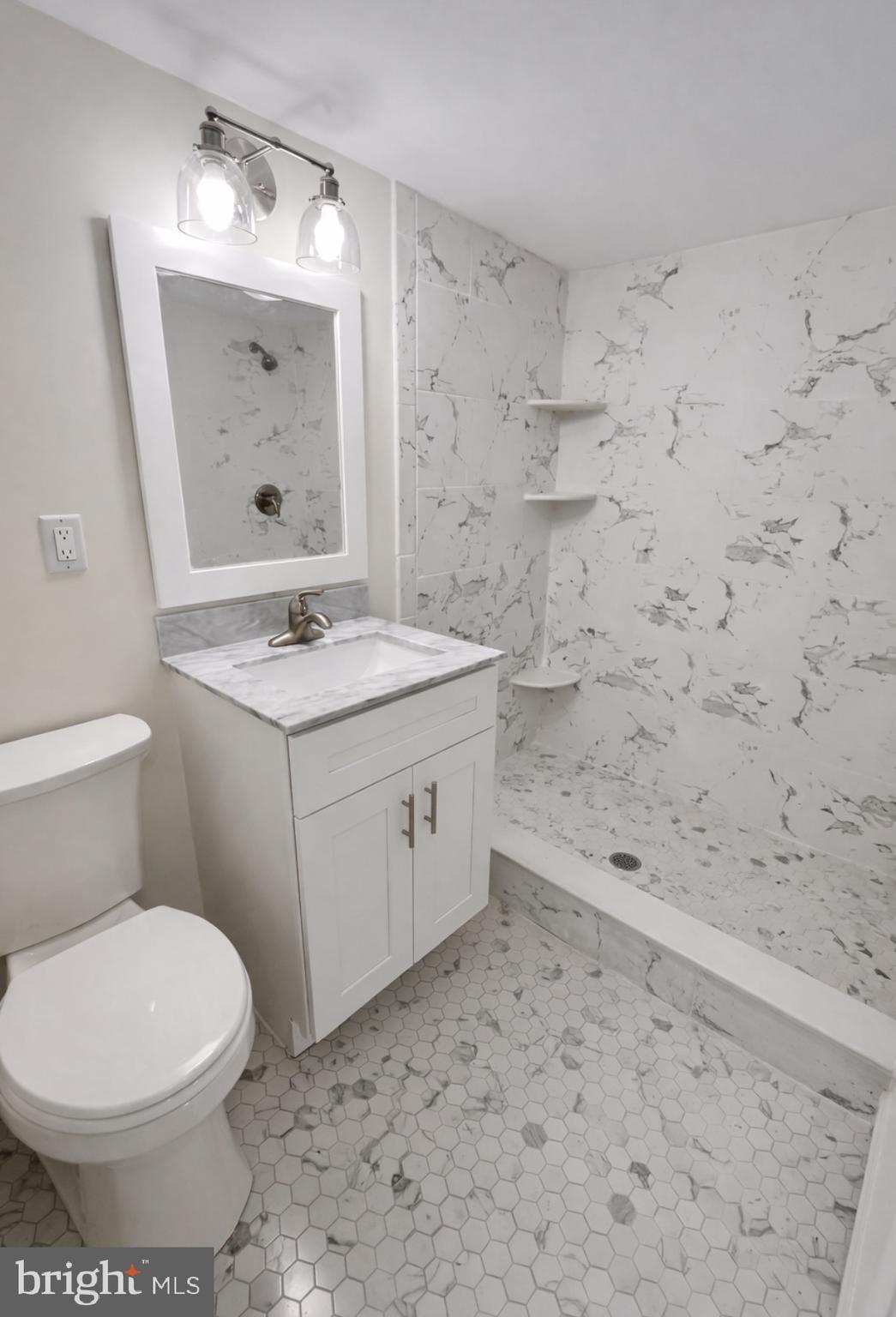 22 Maple Street Conshohocken, PA 19428 - Photo 21 of 22 a bathroom with a sink a toilet and mirror