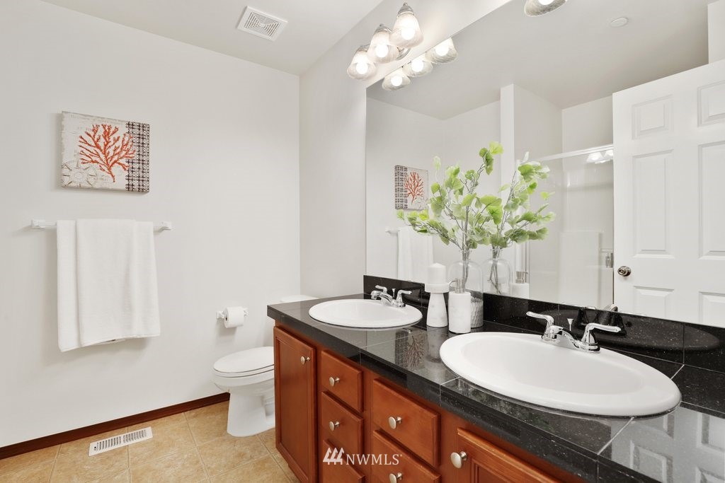 21302 11th Drive Southeast Bothell, WA 98021 - Photo 22 of 37 a bathroom with a granite countertop sink and a mirror