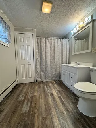 a bathroom with a toilet a sink and mirror