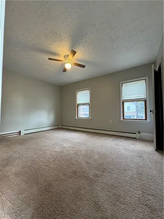 an empty room with a empty space and windows