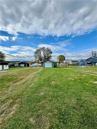 a view of a green field with sitting area