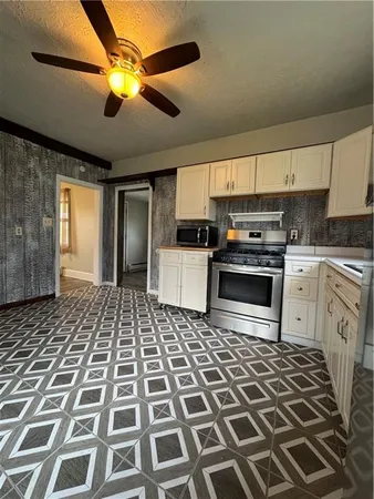 a kitchen with a stove a sink and a microwave