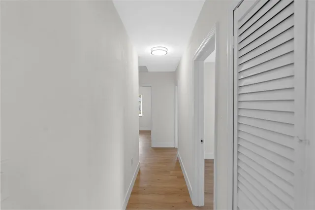 a view of a hallway with wooden floor