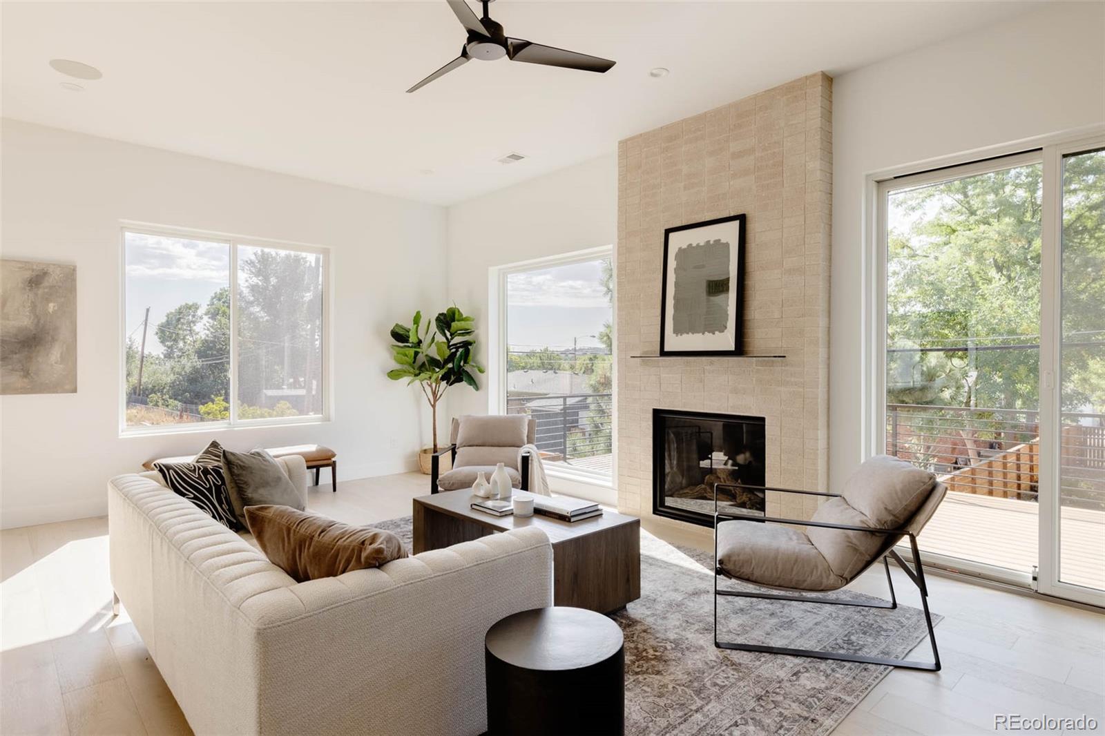 3908 Upham Street Wheat Ridge, CO 80033 - Photo 13 of 35 a living room with furniture and a fireplace
