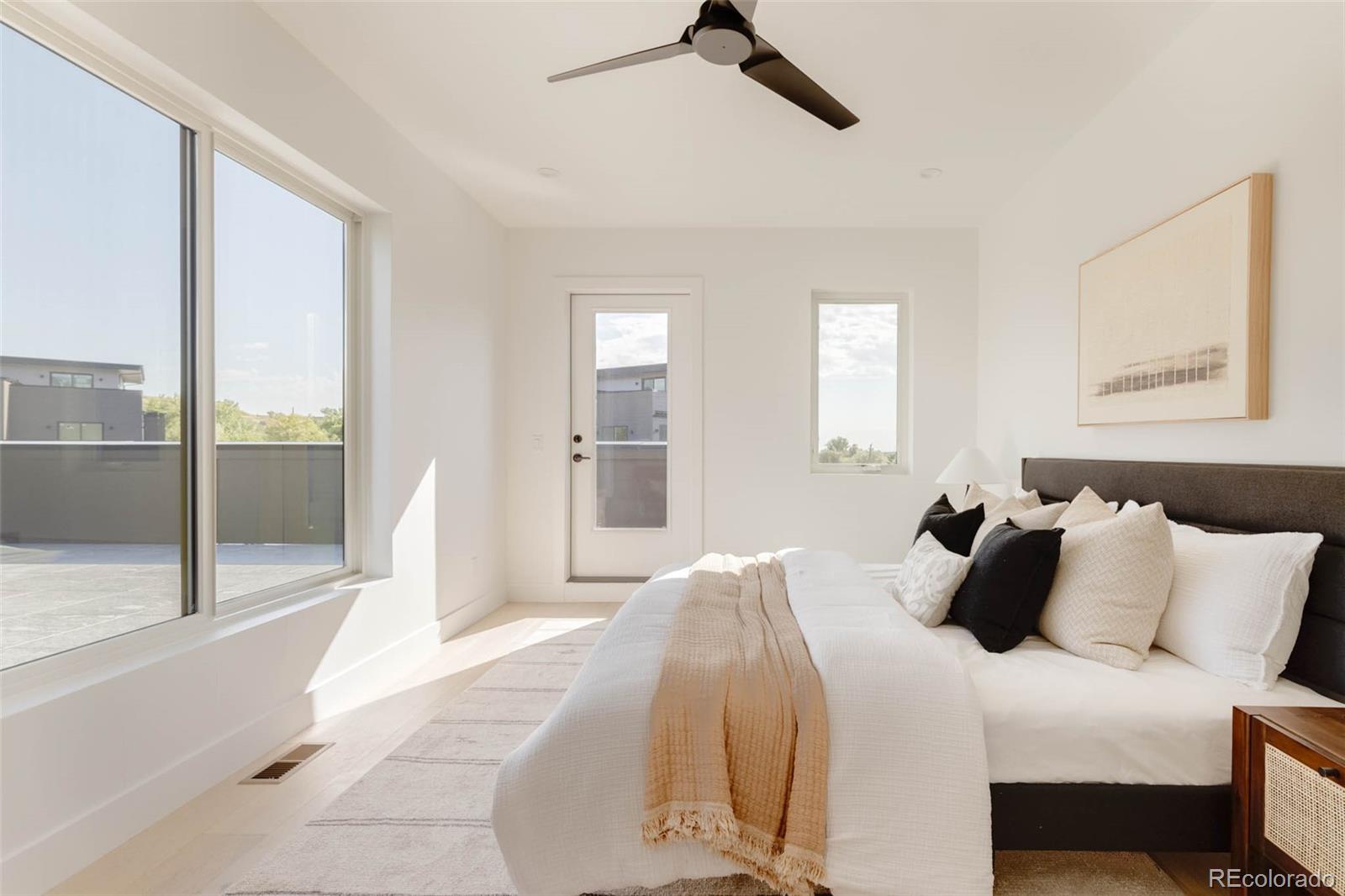 3908 Upham Street Wheat Ridge, CO 80033 - Photo 14 of 35 a bedroom with a bed and glass door