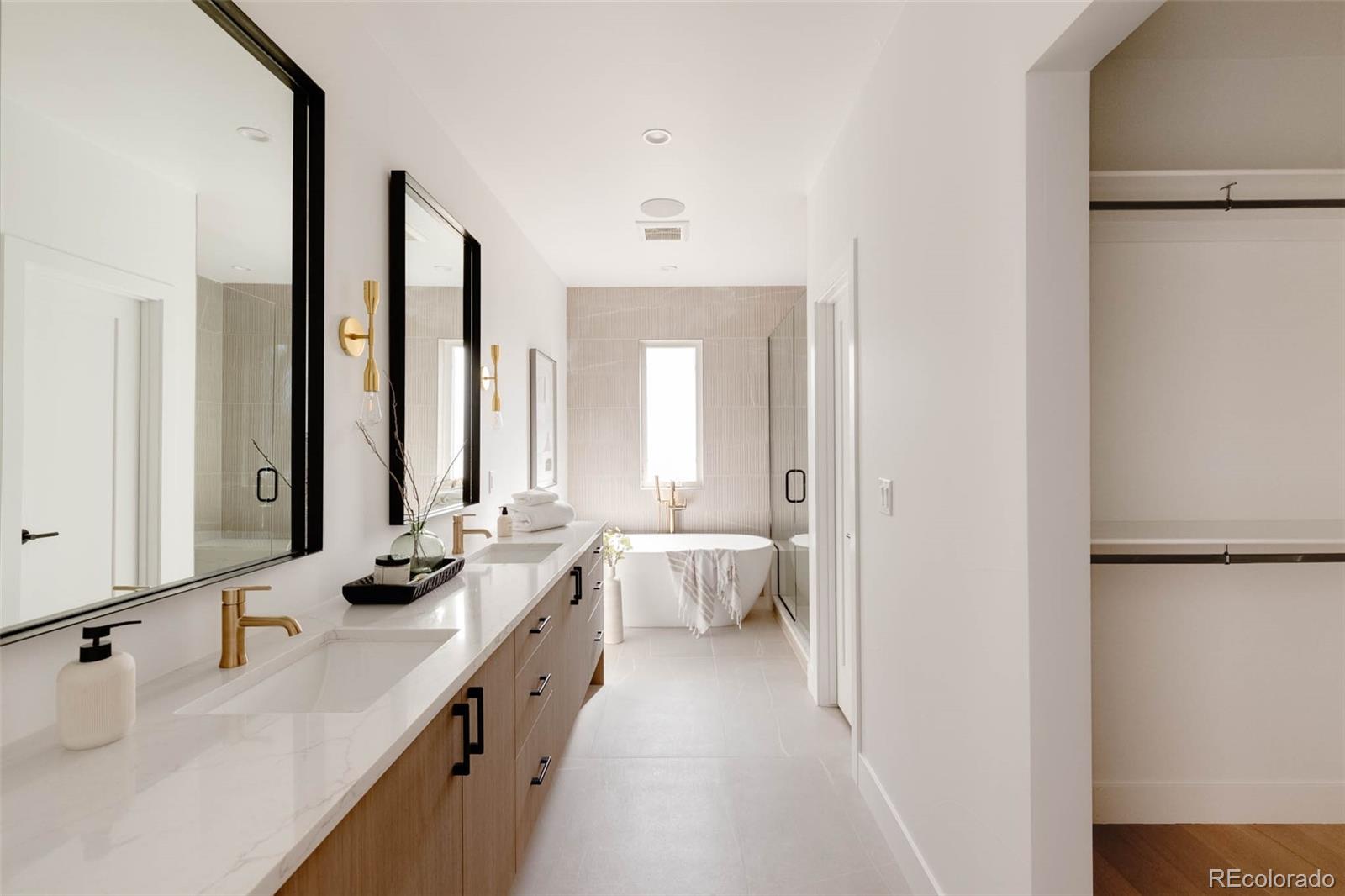 3908 Upham Street Wheat Ridge, CO 80033 - Photo 15 of 35 a bathroom with a double vanity sink mirror and double
