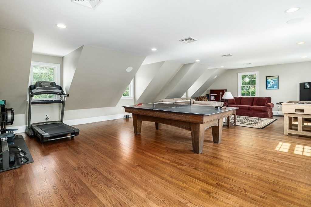 17 Patton Drive Hamilton, MA 01982 - Photo 19 of 37 a living room with furniture a wooden floor and gym equipment