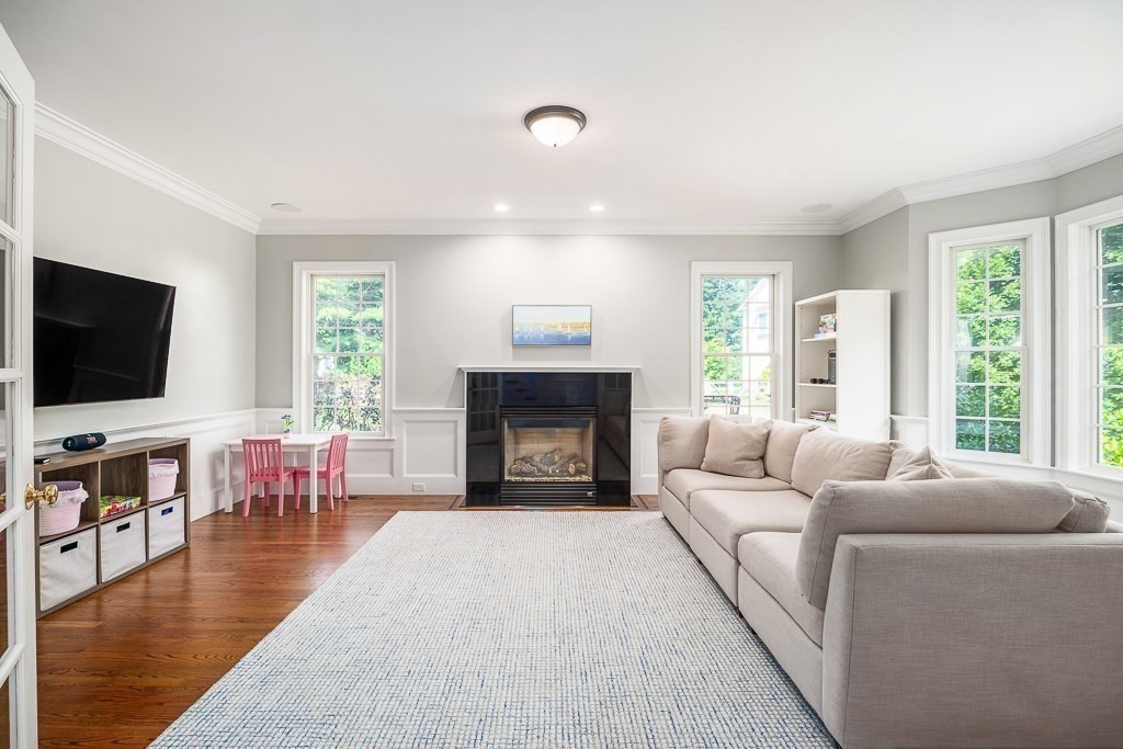 17 Patton Drive Hamilton, MA 01982 - Photo 6 of 37 a living room with furniture a flat screen tv and a fireplace