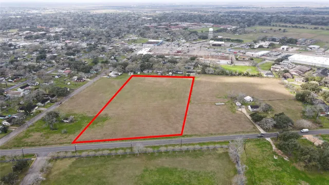 an aerial view of residential houses with outdoor space and swimming pool