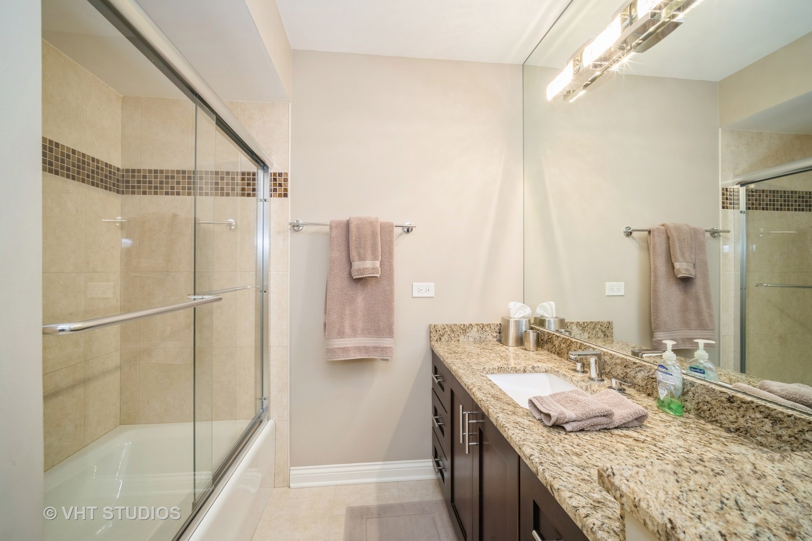 1831 Mission Hills Road, Unit 112 Northbrook, IL 60062 - Photo 11 of 17 a bathroom with a granite countertop sink a mirror and shower