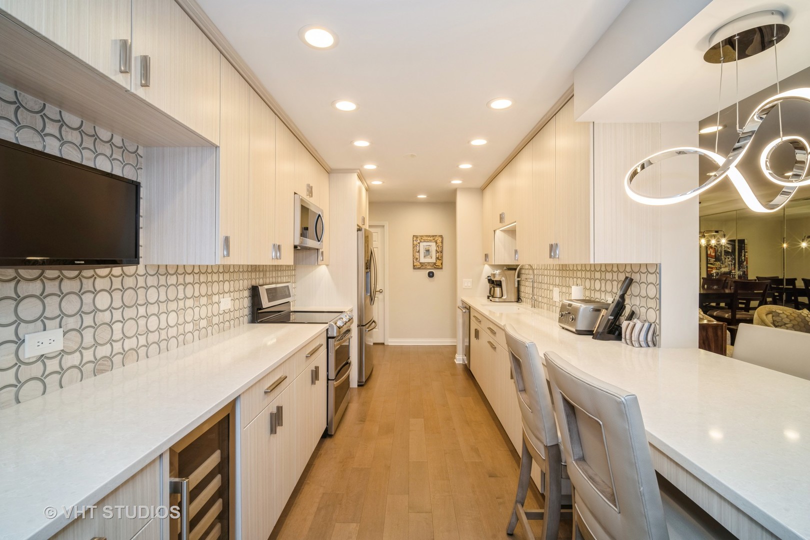 1831 Mission Hills Road, Unit 112 Northbrook, IL 60062 - Photo 8 of 17 a large white kitchen with a large window a sink and a stove