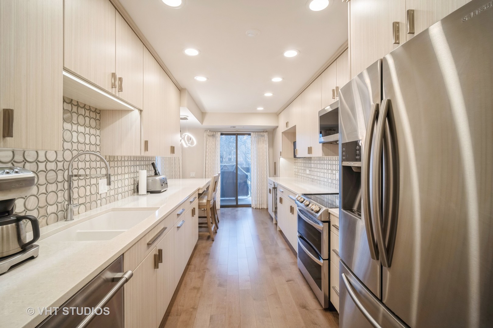 1831 Mission Hills Road, Unit 112 Northbrook, IL 60062 - Photo 9 of 17 a large kitchen with stainless steel appliances sink a stove and a refrigerator