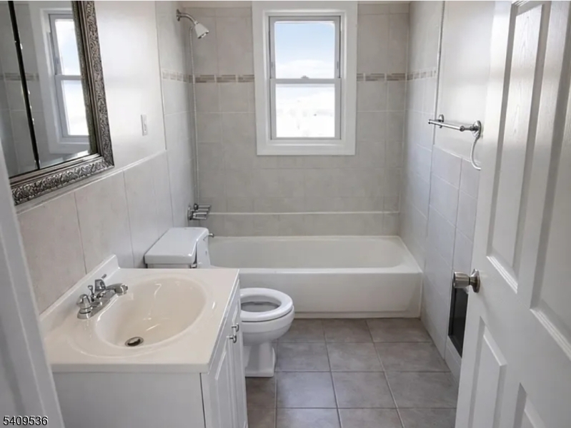 1066 Mary Street Elizabeth, NJ 07201 - Photo 5 of 6 a bathroom with a sink a toilet and a bathtub